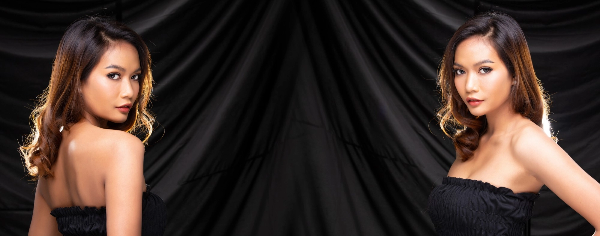 A beautiful Asian escort laying seductively on a sofa